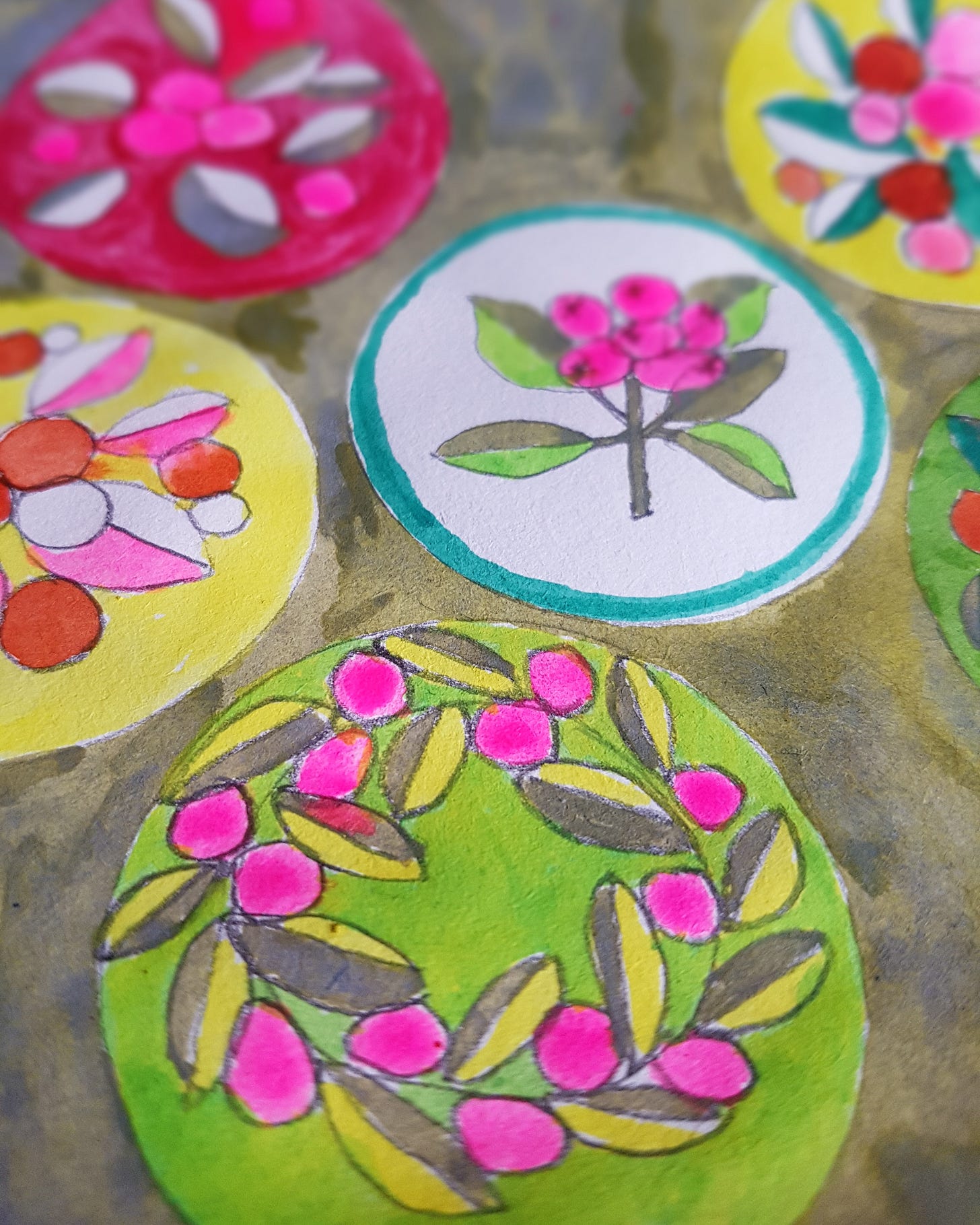 Close up of sketchbook page showing colourful circles filled with leaves and berries.