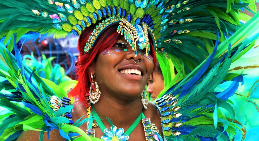 A woman with red hair and green feathers on her costume A woman with red hair and green feathers on her costume