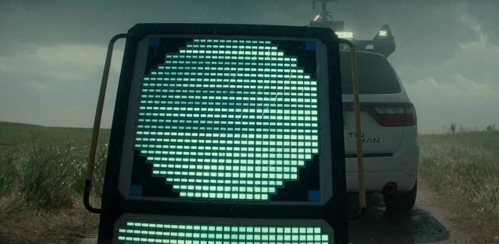 A glowing hexagon being towed down a road - about the size of a Lazy-Boy chair