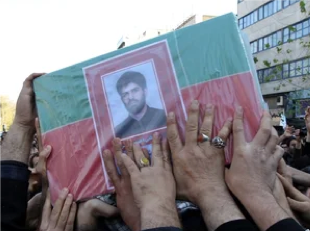 Iranians carry the coffin of nuclear scientist Mostafa Ahmadi-Roshan on Jan. 13, 2012. Ahmadi-Roshan, a deputy director of Iran’s main uranium enrichment plant was killed on Jan 11. when two men on a motorbike slapped a magnetic bomb on his car in Tehran. Atta Kenare/AFP/Getty Images