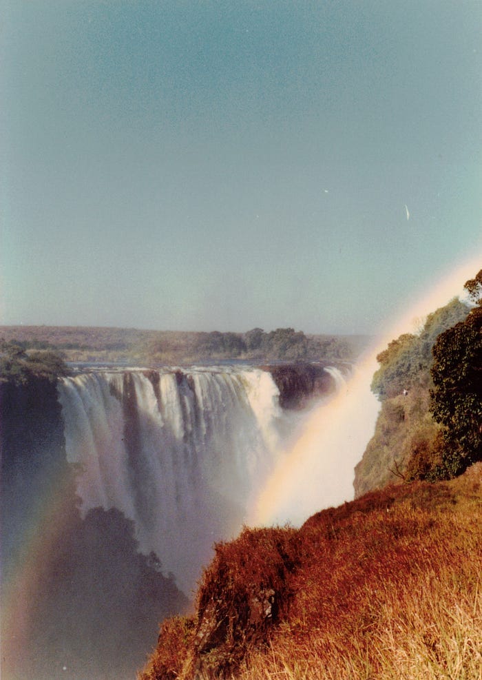 Waterfall seen from downstream side, with rainbow across one side.