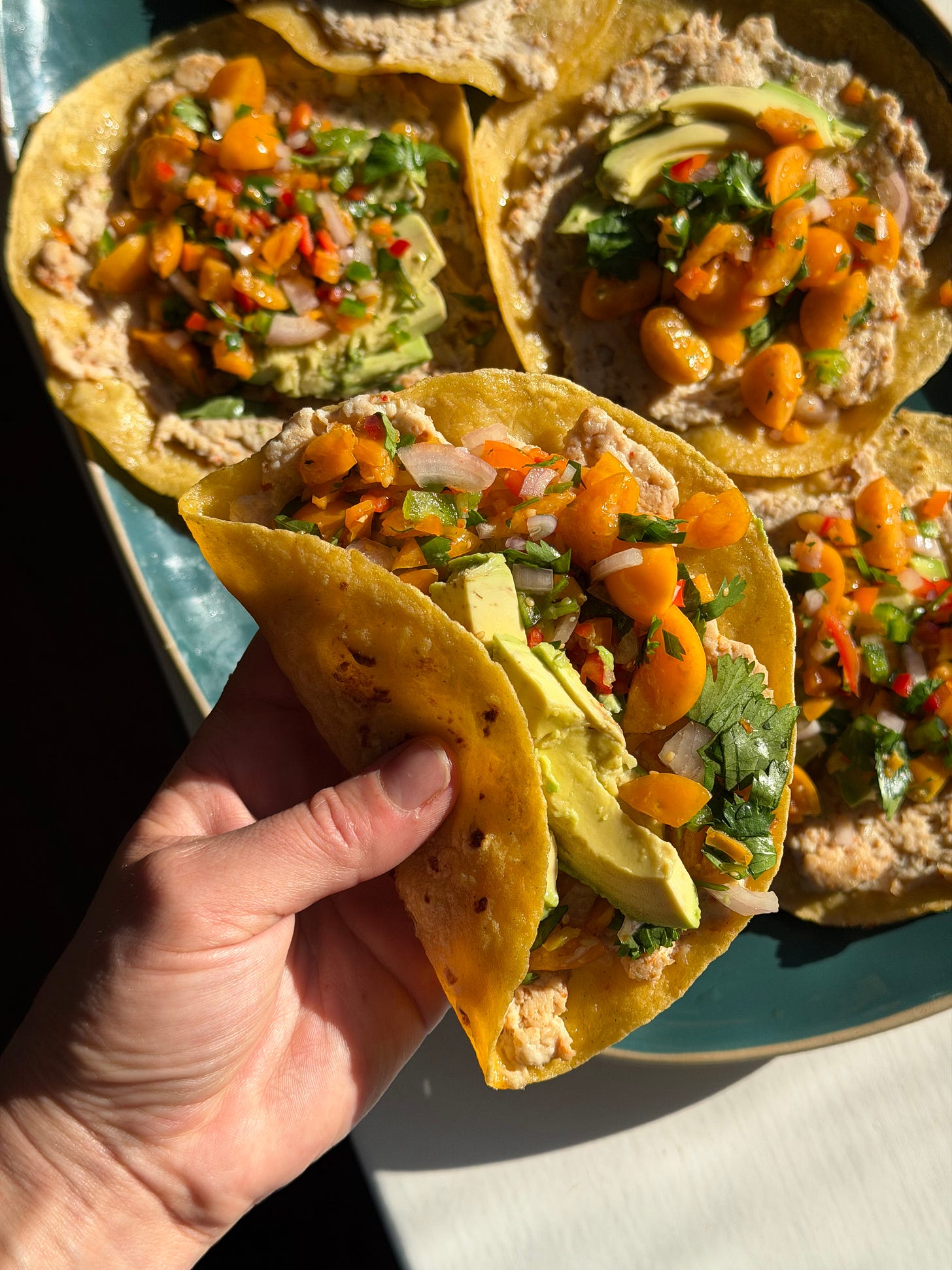 turkey smash taco topped with golden berry salsa and avocado slices