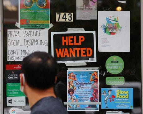 A ‘help wanted’ sign in the door of a hardware store