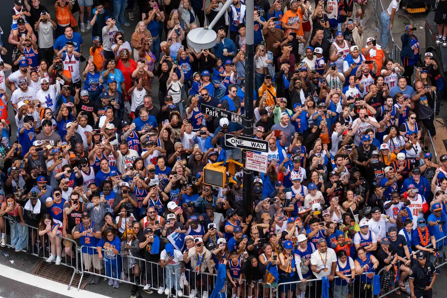 Fans watch the New York Knicks Championship ticker-tape parade on June 18, 2026 in New York City. The New York Knicks celebrate during the Championship ticker tape parade and victory rally celebrating winning the 2026 NBA Finals on June 18, 2026 in New York City. 