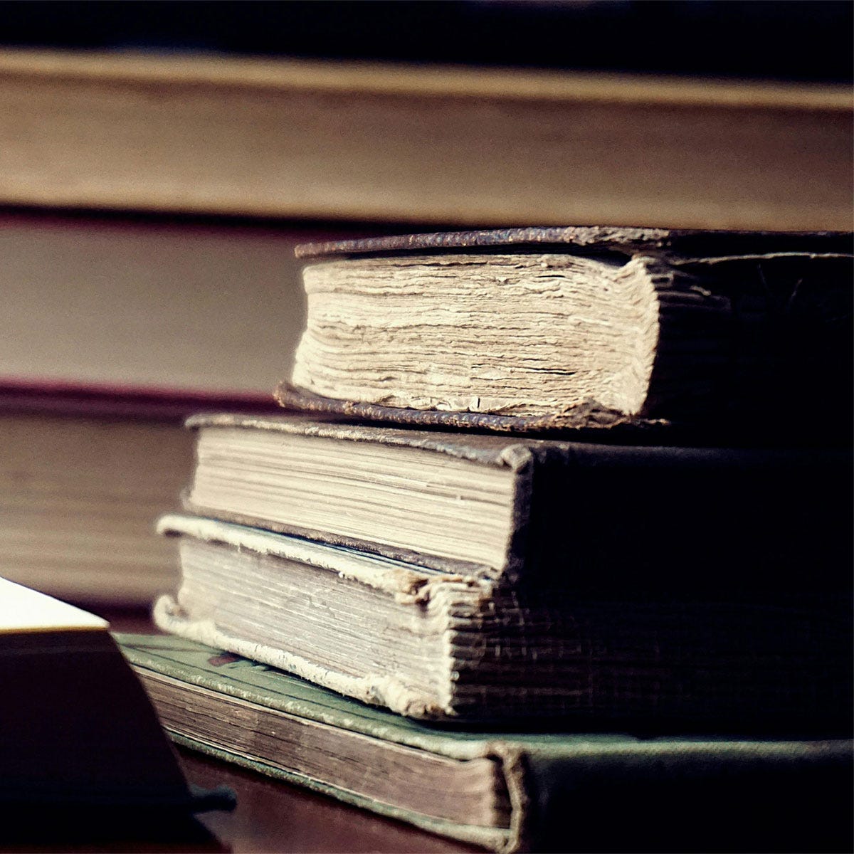 Old books on a desk. Image via Suzy Hazelwood