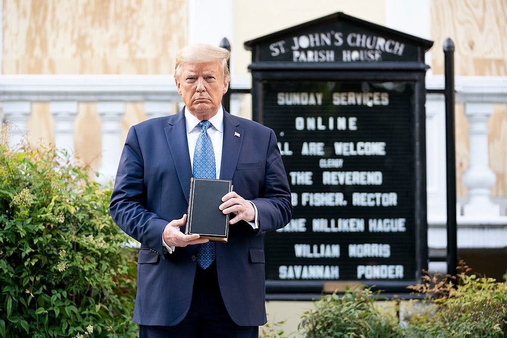 President Donald Trump, dressed in a dark blue suit with a light blue tie and white dress shirt, holds a copy of the Bible in front of Ashburton House, a former private residence which now serves as the priory house of St. John's Episcopal Church just north of Lafayette Square. St. John's is popularly known as the "Church of the Presidents" because every president since James Madison has attended services there at least once, typically on the day of their inauguration. President Donald Trump, dressed in a dark blue suit with a light blue tie and white dress shirt, holds a copy of the Bible in front of Ashburton House, a former private residence which now serves as the priory house of St. John's Episcopal Church just north of Lafayette Square. St. John's is popularly known as the "Church of the Presidents" because every president since James Madison has attended services there at least once, typically on the day of their inauguration.