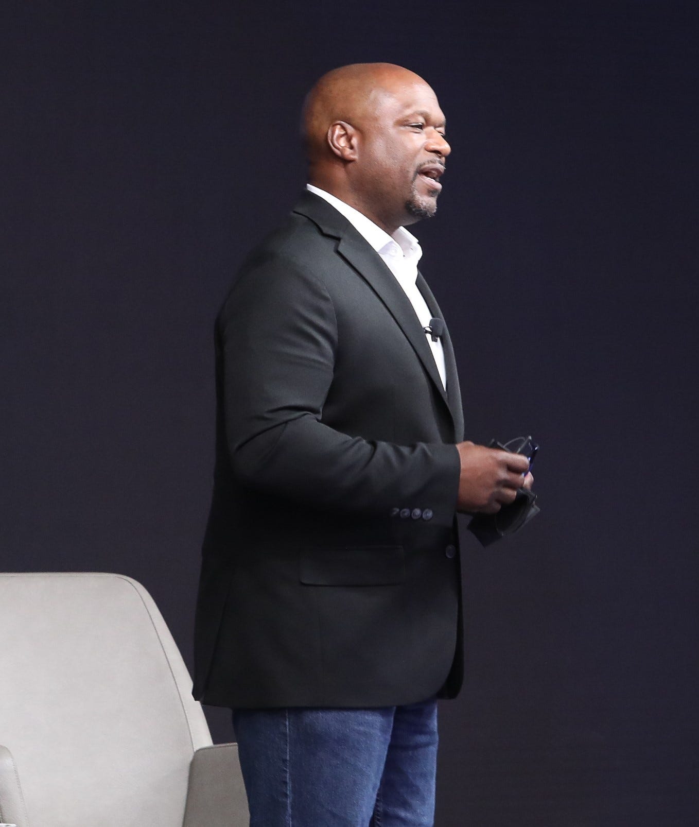 Coach Chris speaking confidently at a keynote presentation about leadership