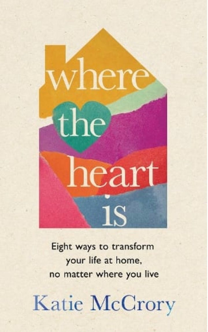 copies of a book with a colourful house shape on the cover