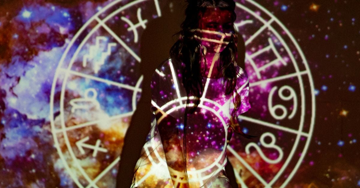 A mystical image of a woman enveloped in celestial projections and astrological symbols.