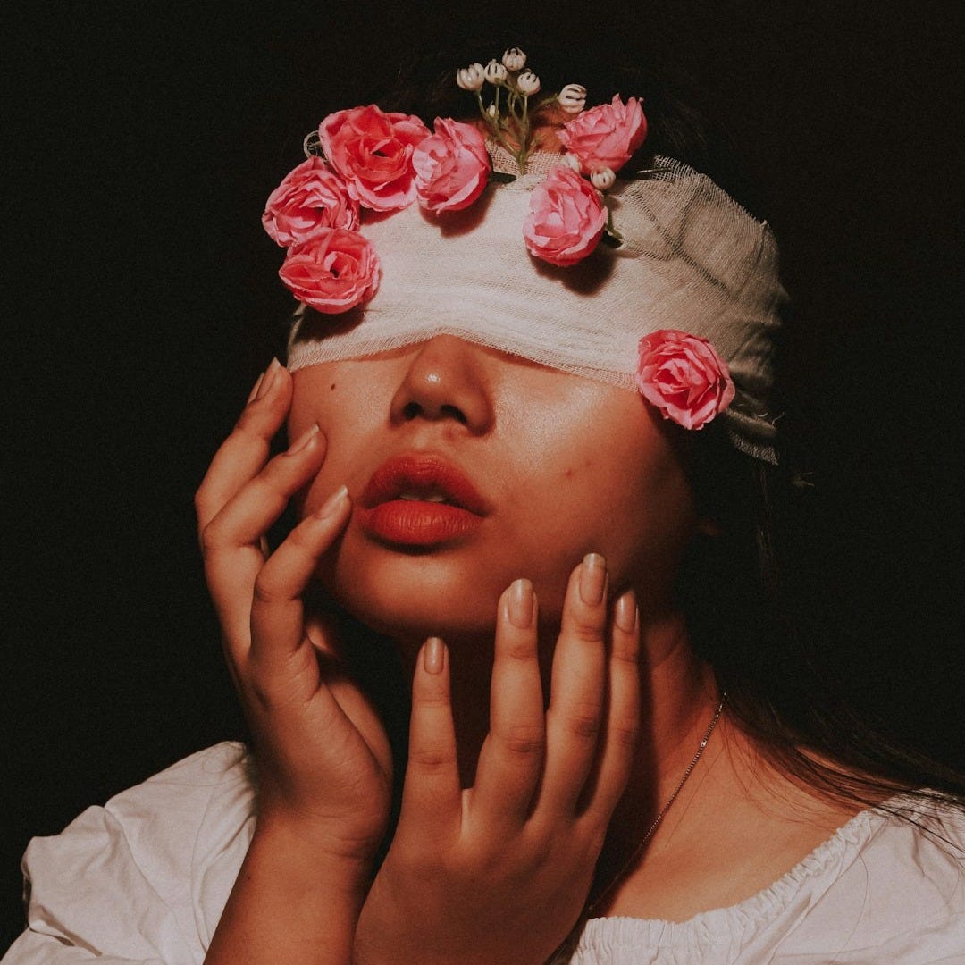 woman in white crew neck shirt with red flower on her face woman in white crew neck shirt with red flower on her face