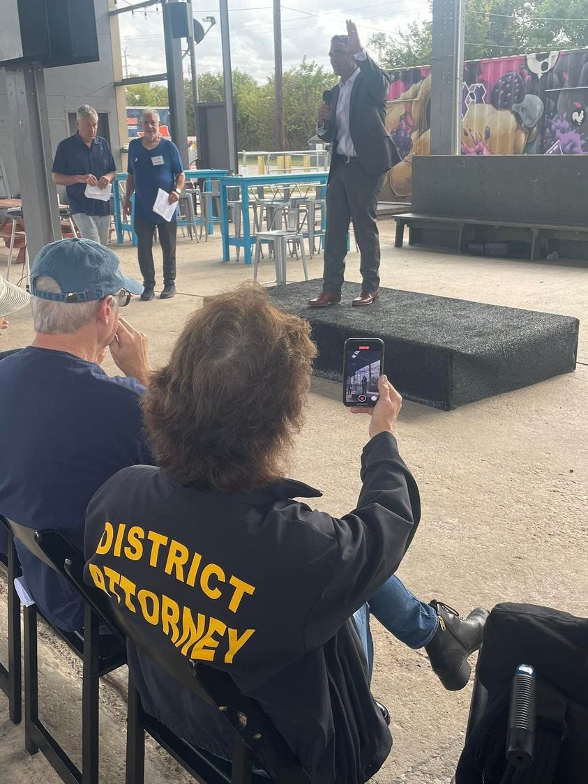 May be an image of 5 people, speaker, crowd and text