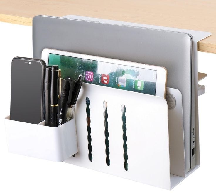 This may contain: a white desk organizer with pens, pencils and cell phones in it's holder