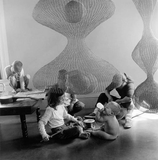 Ruth surrounded by her wire sculptures and four of her six children
