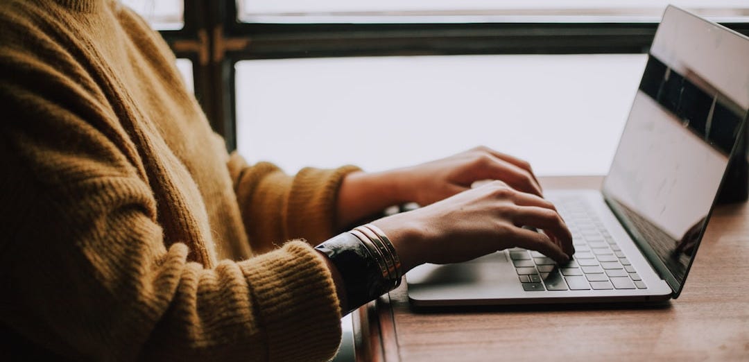 person sitting front of laptop