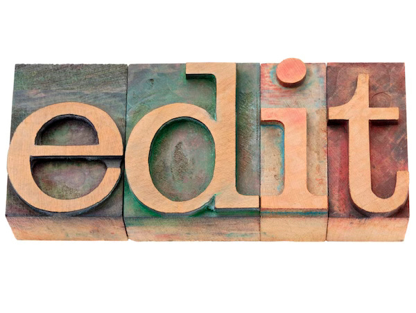 Four woodblocks spelling the word EDIT