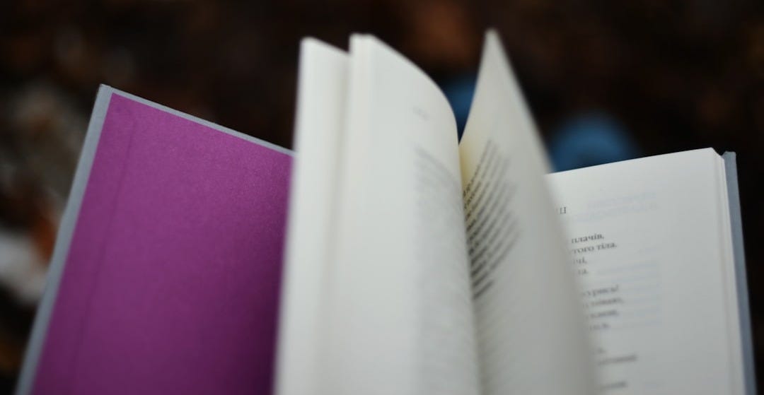 An open book with purple binding. An open book with purple binding.