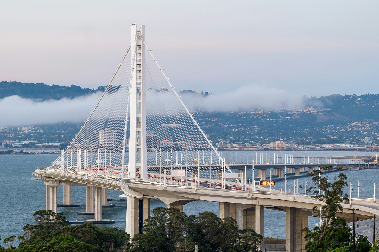 a big, white bridge above a sea. a big, white bridge above a sea.