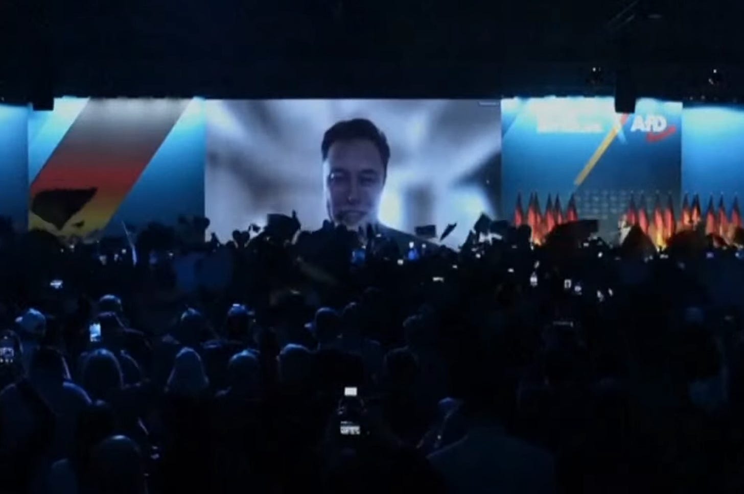 Musk beamed in over the audience on giant screens