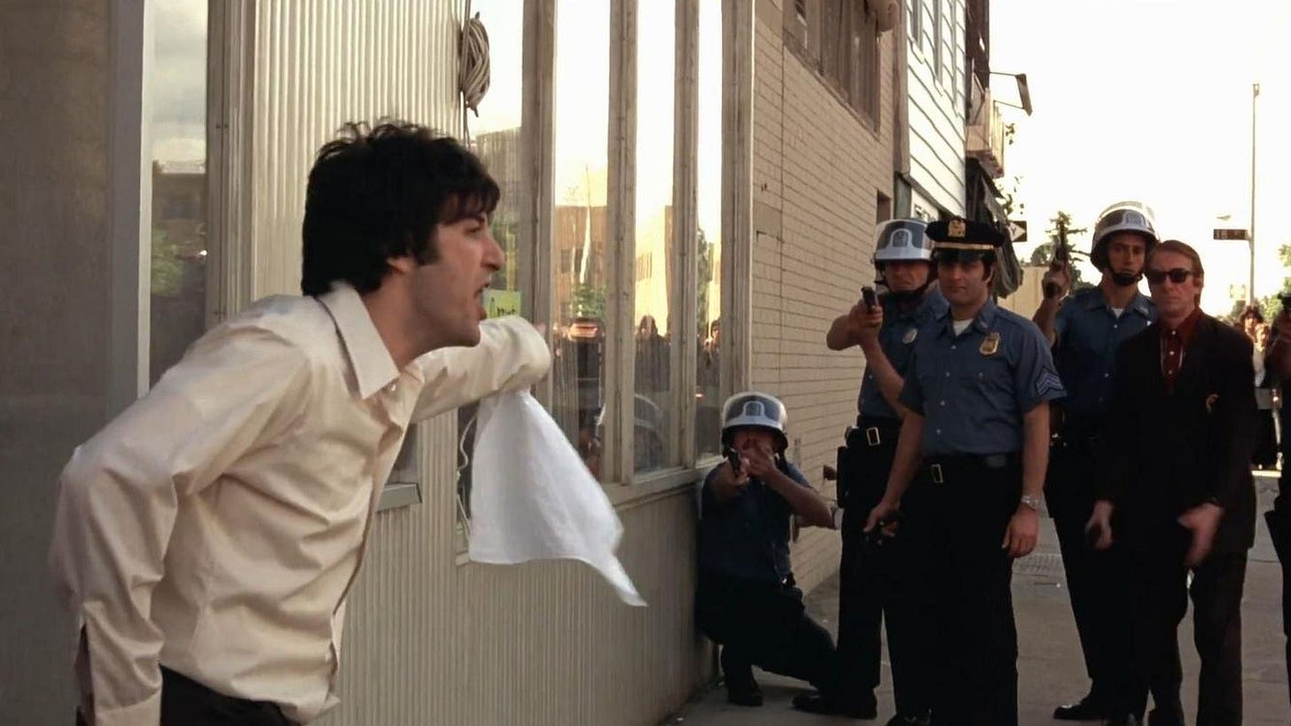 Dog Day Afternoon | Still features Al Pacino as Sonny Wortzik reprimanding onlooking police officers.
