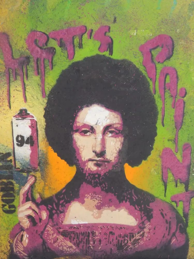 Street art - a head and shoulders image of a man with the words "Let's paint" surrounding it 