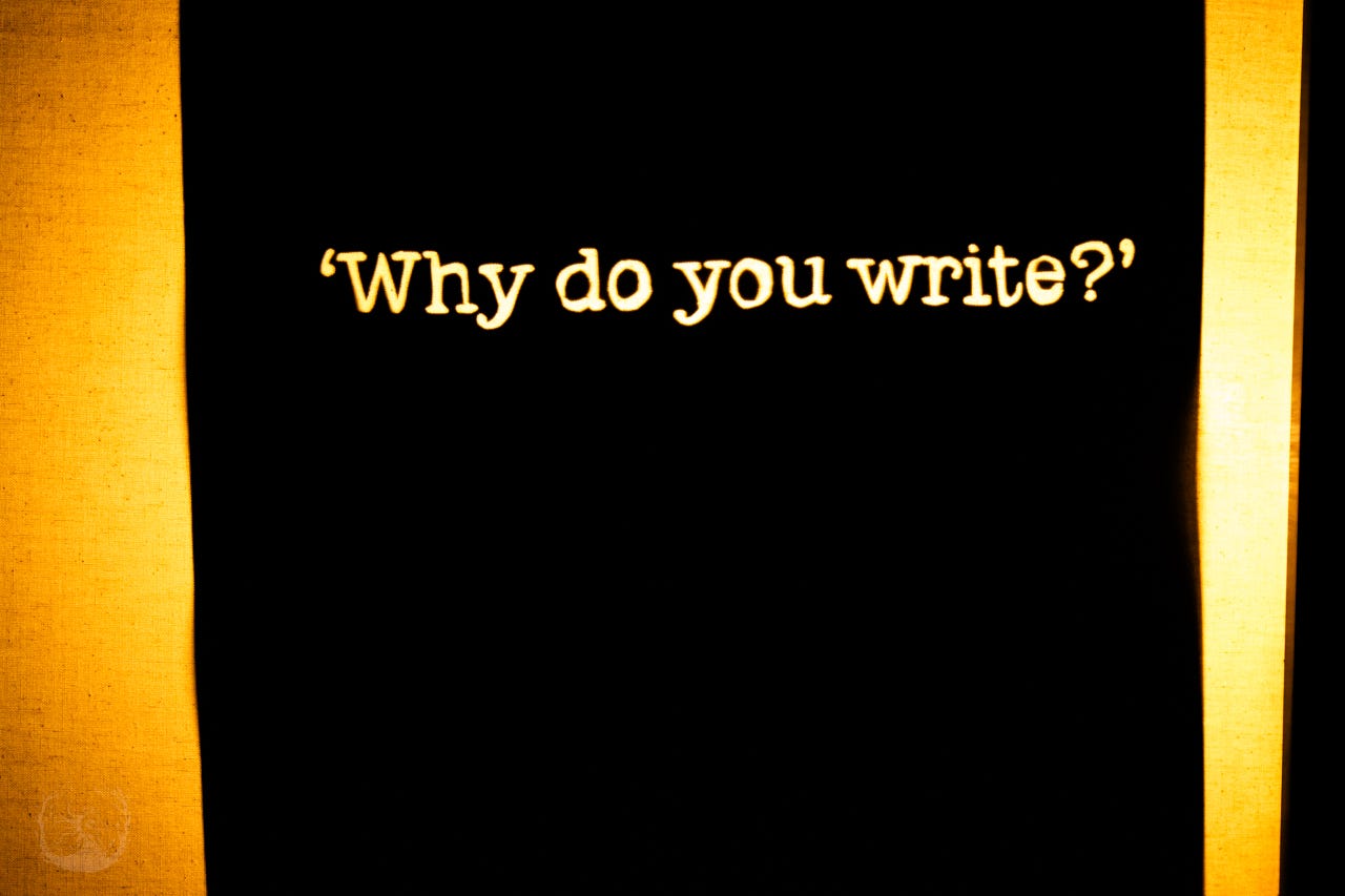 A photograph of a shadow cutout that reads 'Why do you write?'