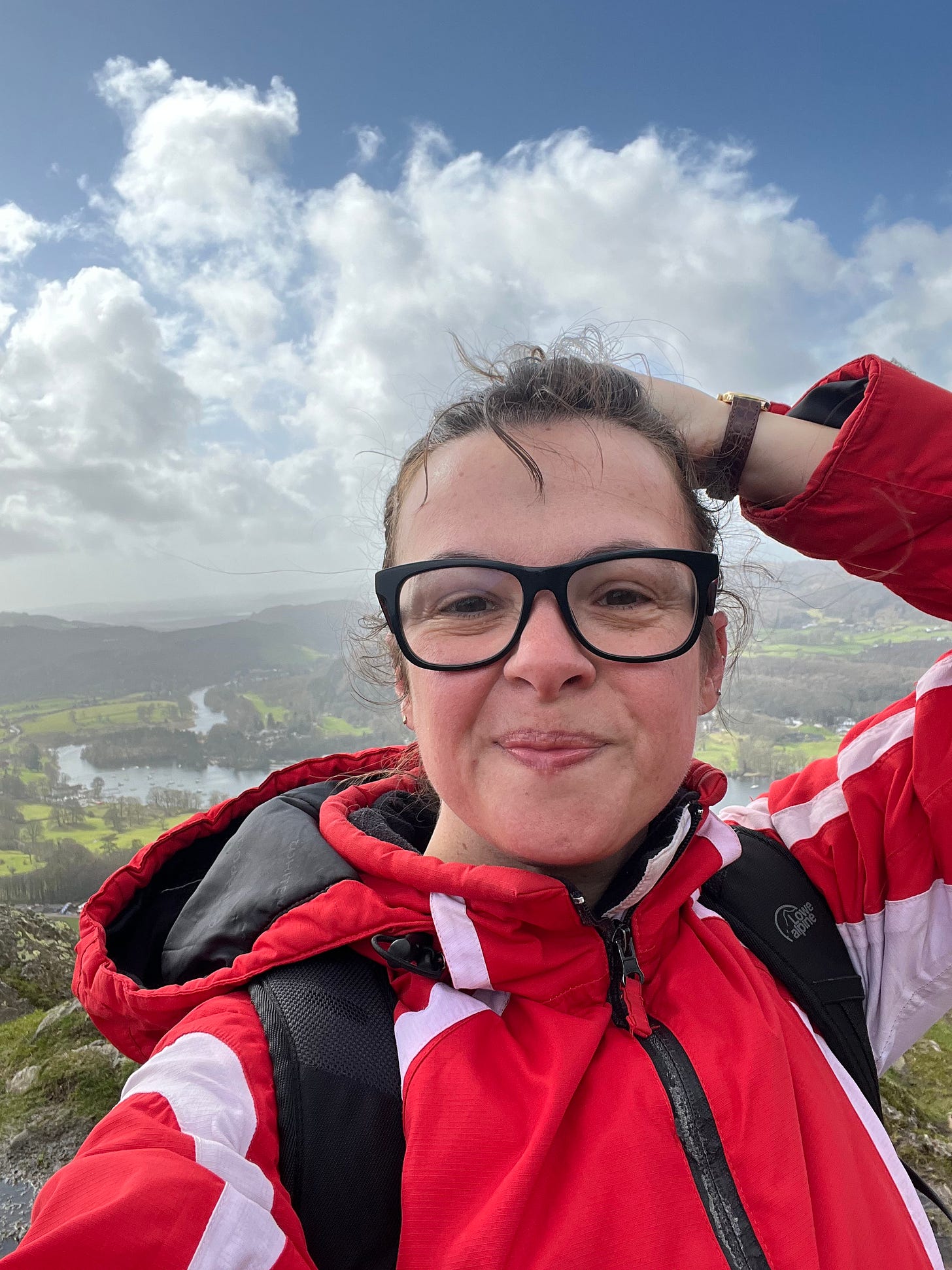 Claire up a hill in a red raincoat
