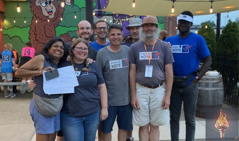 Kalamazoo Rank MI Vote volunteers at One Well Brewing on Saturday, July 16, 2022, following a day of canvassing the Milwood neighborhood. Pictured in the front row (L to R) are Christina Dorett, Brianna Wurtsmith, Ron Zimmerman, and Jeff Messer. Pictured in the back row (L to R) are Dave Wurtsmith, Bryan Winder, Barry Kitch, and Ben Quartey. Not pictured, but also helping that day, is Sabrina Kooy. Kalamazoo Rank MI Vote volunteers at One Well Brewing on Saturday, July 16, 2022, following a day of canvassing the Milwood neighborhood. Pictured in the front row (L to R) are Christina Dorett, Brianna Wurtsmith, Ron Zimmerman, and Jeff Messer. Pictured in the back row (L to R) are Dave Wurtsmith, Bryan Winder, Barry Kitch, and Ben Quartey. Not pictured, but also helping that day, is Sabrina Kooy.
