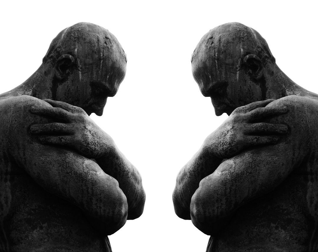 a statue of a man holding his hands to his chest a statue of a man holding his hands to his chest