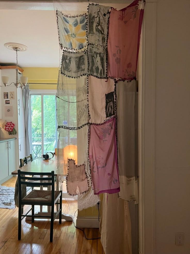 This may contain: the curtains are hanging on the wall in the kitchen and dinning room with wood flooring