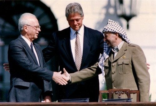 PLO Chairman Yasser Arafat (R) shakes hands with Israeli Prime Minister Yitzhak Rabin (L), as U.S. President Bill Clinton stands between them, after the signing of the Israeli-PLO peace accord, at the White House in Washington September 13, 1993. REUTERS/Gary Hershorn (UNITED STATES - Tags: POLITICS) - GM1E99D1UCD01 PLO Chairman Yasser Arafat (R) shakes hands with Israeli Prime Minister Yitzhak Rabin (L), as U.S. President Bill Clinton stands between them, after the signing of the Israeli-PLO peace accord, at the White House in Washington September 13, 1993. REUTERS/Gary Hershorn (UNITED STATES - Tags: POLITICS) - GM1E99D1UCD01