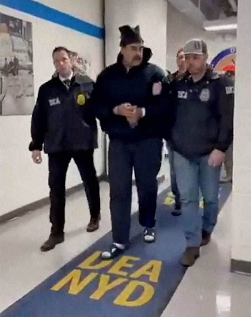 A still image from video posted by the White House’s Rapid Response 47 account on X.com, which originated from the @PaulDMauro account, shows Venezuela’s President Nicolas Maduro being walked in custody down a hallway at the offices of the U.S. Drug Enforcement Administration (DEA) in New York… A still image from video posted by the White House’s Rapid Response 47 account on X.com, which originated from the @PaulDMauro account, shows Venezuela’s President Nicolas Maduro being walked in custody down a hallway at the offices of the U.S. Drug Enforcement Administration (DEA) in New York…