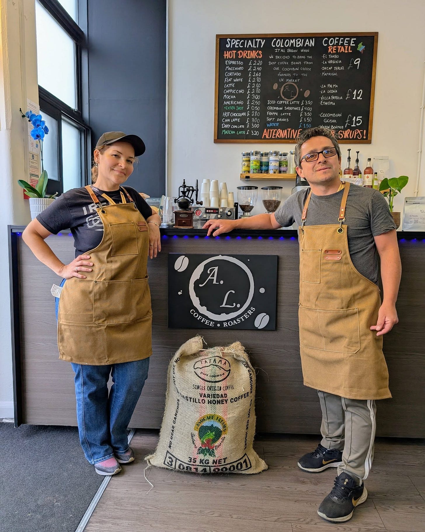 May be an image of 2 people, coffee maker, grinder, coffee cup, cornflower and text that says "SPECIALTYCOLOMBIANCOFFEE RETALL SPECIALTY COLOMBIAN COFFEE HOTDRINKS ESPVESTO FAEWITE c CAFRCCNO FoNPN 12 InrConieN/300 AUTERNATINE AJERMAT 15 SHRUPS! Ά. COFFEE EE ROAST COP RS TATAMA SIAGLE 0花建 STILLOHONER OMEY STILLO B35KGNET 35KGNET OR147"