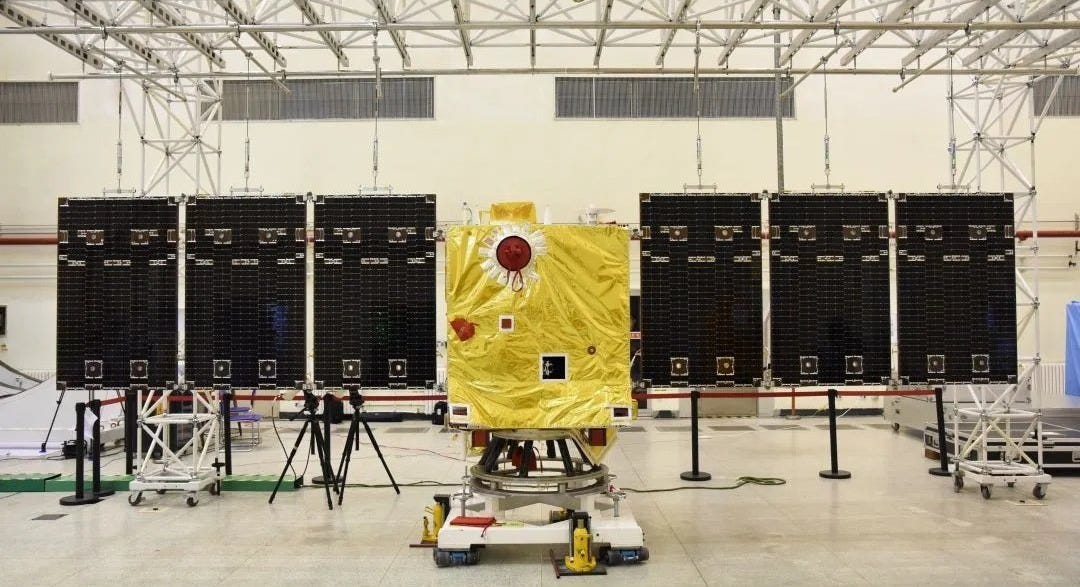 The Xihe solar monitoring satellite in a cleanroom, undergoing testing of its solar panel deployment mechanism.