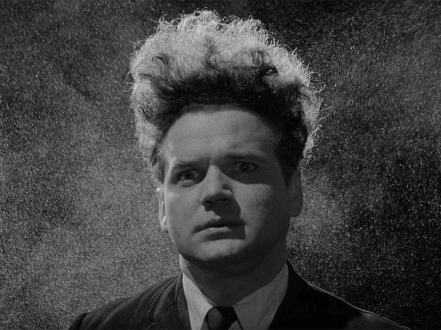 startled man in tie against grey fuzz background; big hair looks like a halo startled man in tie against grey fuzz background; big hair looks like a halo