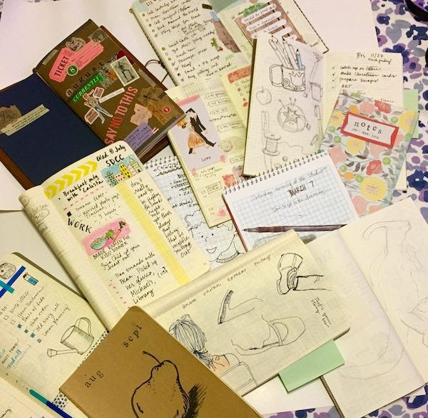 A bed strewn with an assortment of notebooks and sketchbooks. A bed strewn with an assortment of notebooks and sketchbooks.