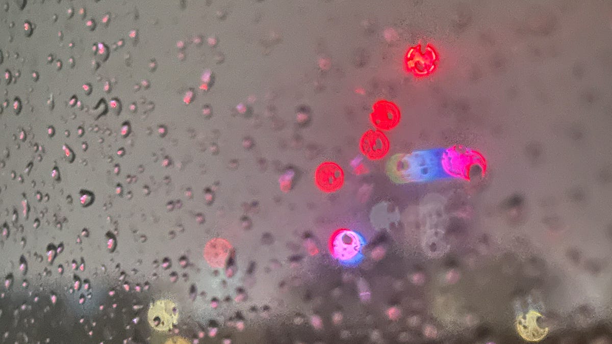 The lights of a city examined through a rain-soaked window The lights of a city examined through a rain-soaked window