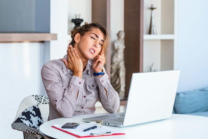 A woman at a computer looking upset.