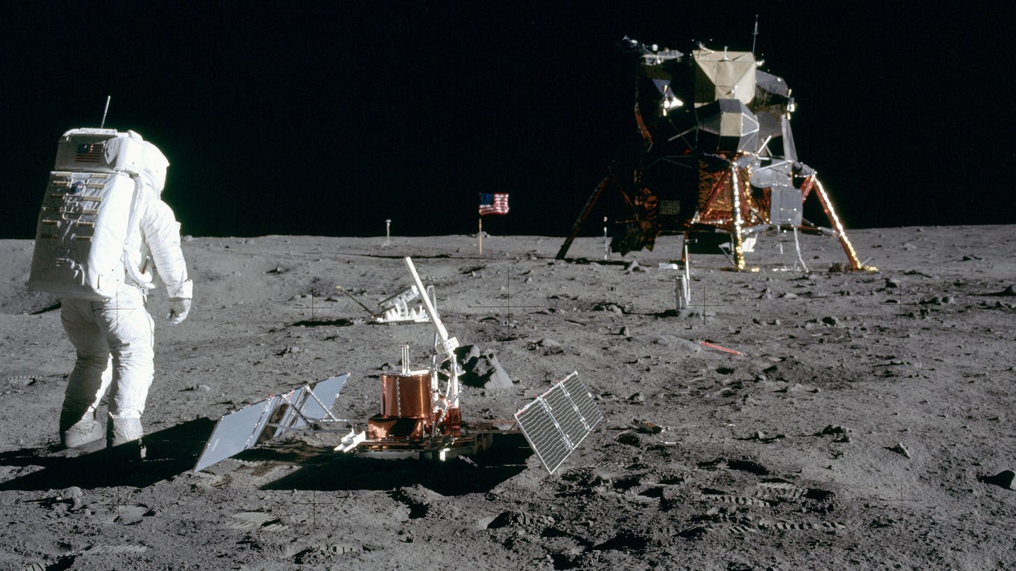 An astronaut stands proudly on the moon's surface near scientific equipment and a lunar lander, as the American flag waves in the background, symbolizing a pioneering USA nation. An astronaut stands proudly on the moon's surface near scientific equipment and a lunar lander, as the American flag waves in the background, symbolizing a pioneering USA nation.