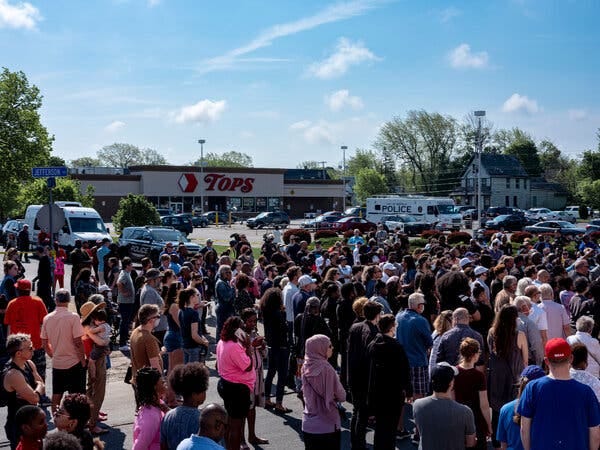 Community members, religious leaders and activists gathered Sunday outside the Tops supermarket in Buffalo where 10 people were killed a day earlier. Community members, religious leaders and activists gathered Sunday outside the Tops supermarket in Buffalo where 10 people were killed a day earlier.