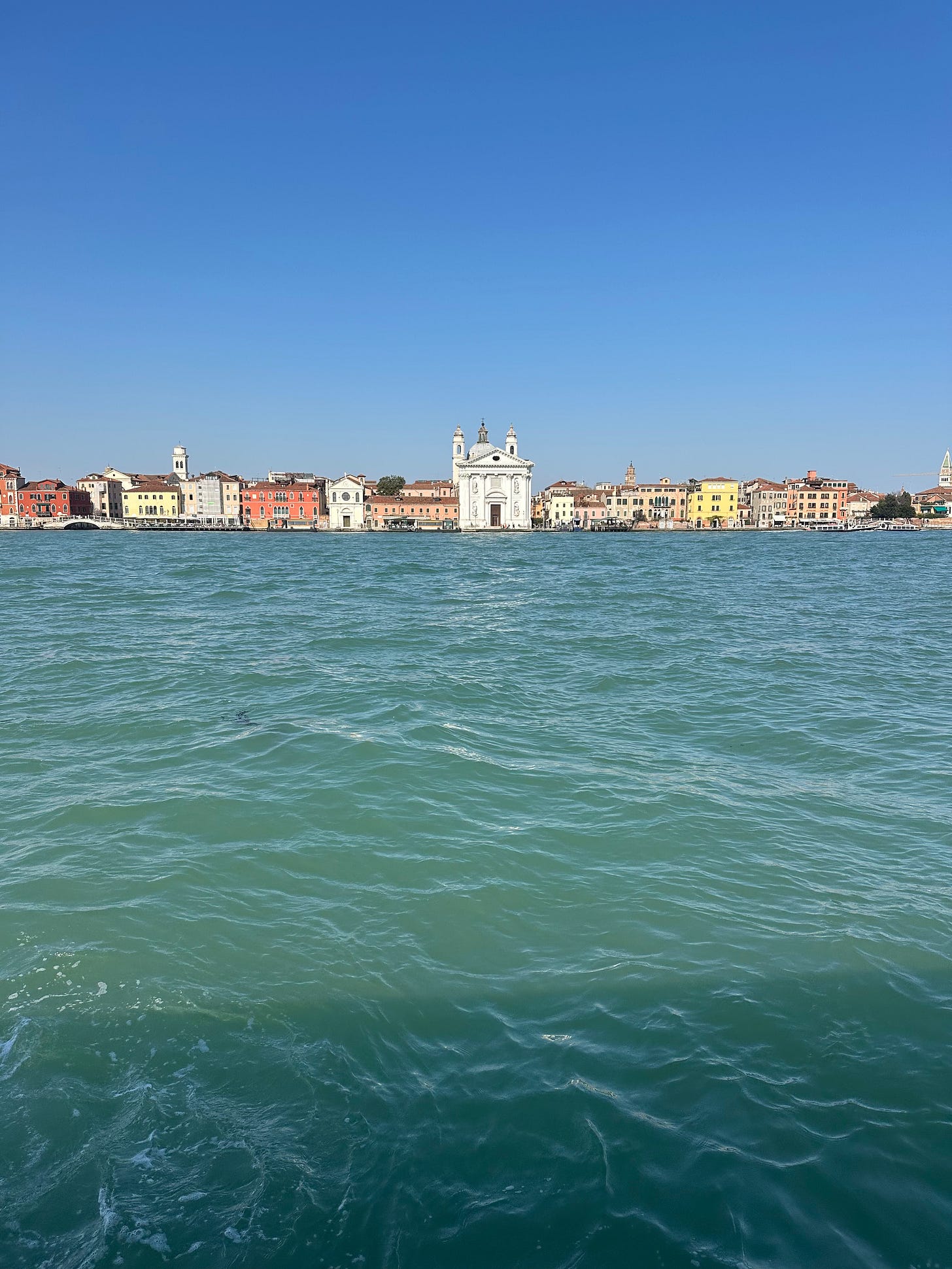 Wide lagoon view in Venice with water, sky and distant shoreline in warm light Wide lagoon view in Venice with water, sky and distant shoreline in warm light