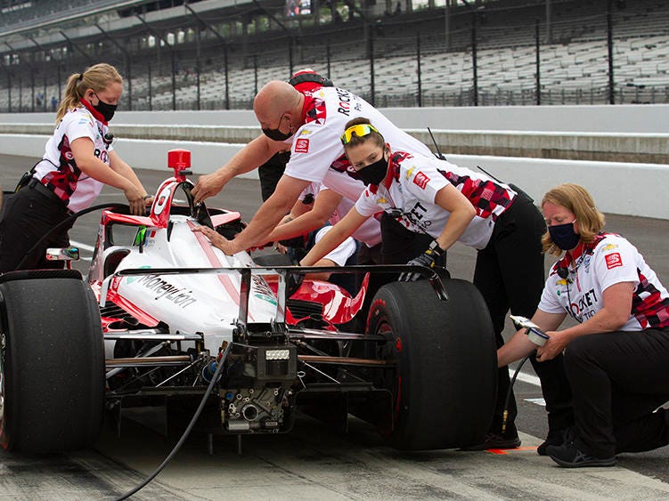 Paretta Autosport crew members work on their car in pit lane at the Indianapolis Motor Speedway during a practice session earlier this week. It could become the first majority-women team to qualify for the Indy 500. DOUG JAGGERS / WFYI Paretta Autosport crew members work on their car in pit lane at the Indianapolis Motor Speedway during a practice session earlier this week. It could become the first majority-women team to qualify for the Indy 500. DOUG JAGGERS / WFYI
