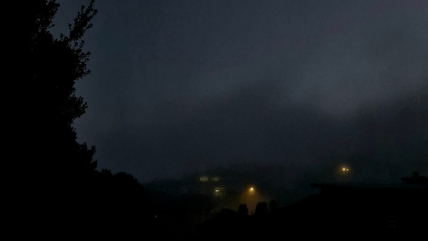 grey image with yellow shafts of light from streetlamps. images are vague and ghostly