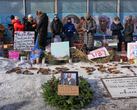 People gather near the scene where Alex Pretti was fatally shot by a US border patrol officer yesterday, in Minneapolis, on Sunday.