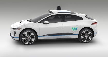 A rendering of a white, I-PACE with the 4th-generation Waymo Driver A rendering of a white, I-PACE with the 4th-generation Waymo Driver