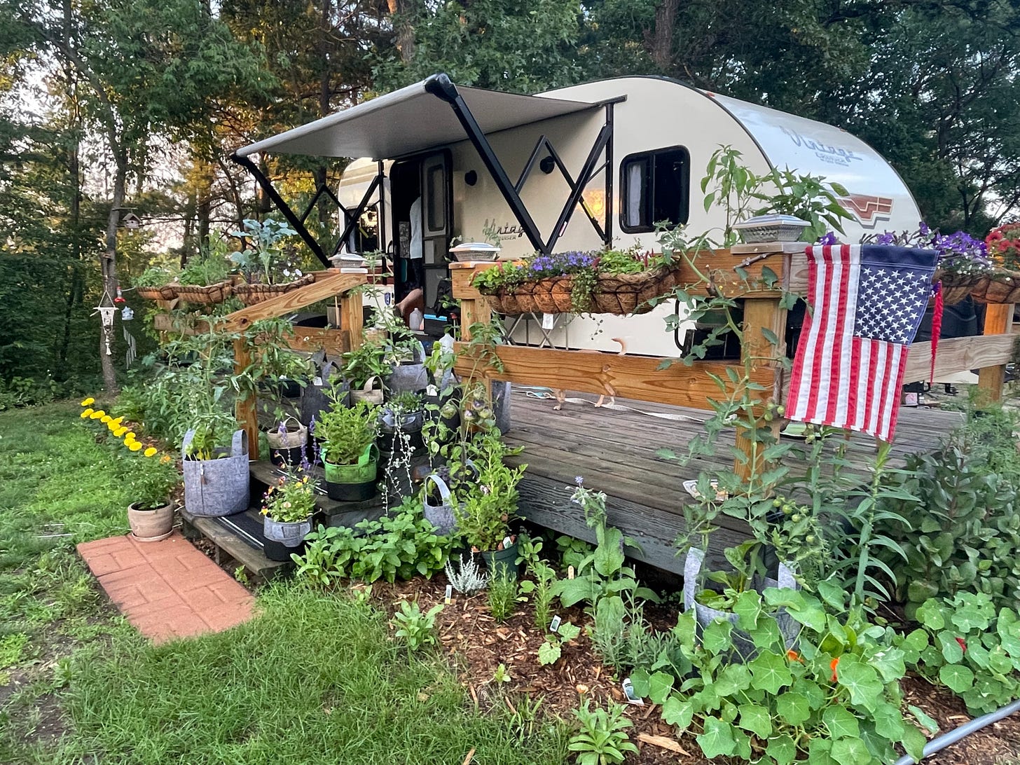 A camper RV with a huge garden around it
