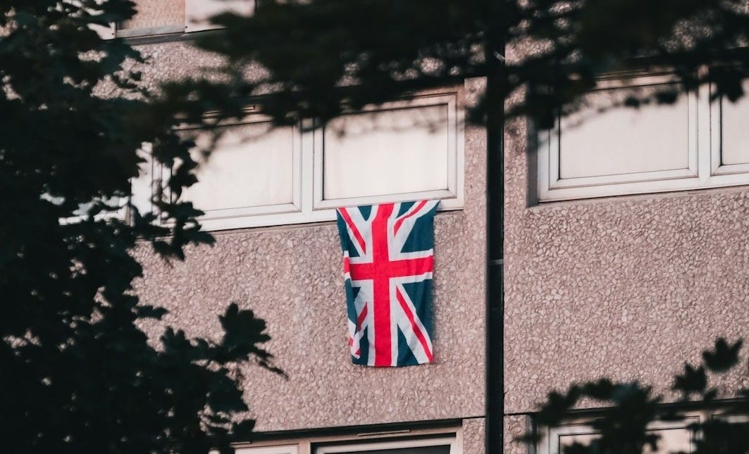 A tall building with a british flag on it's side