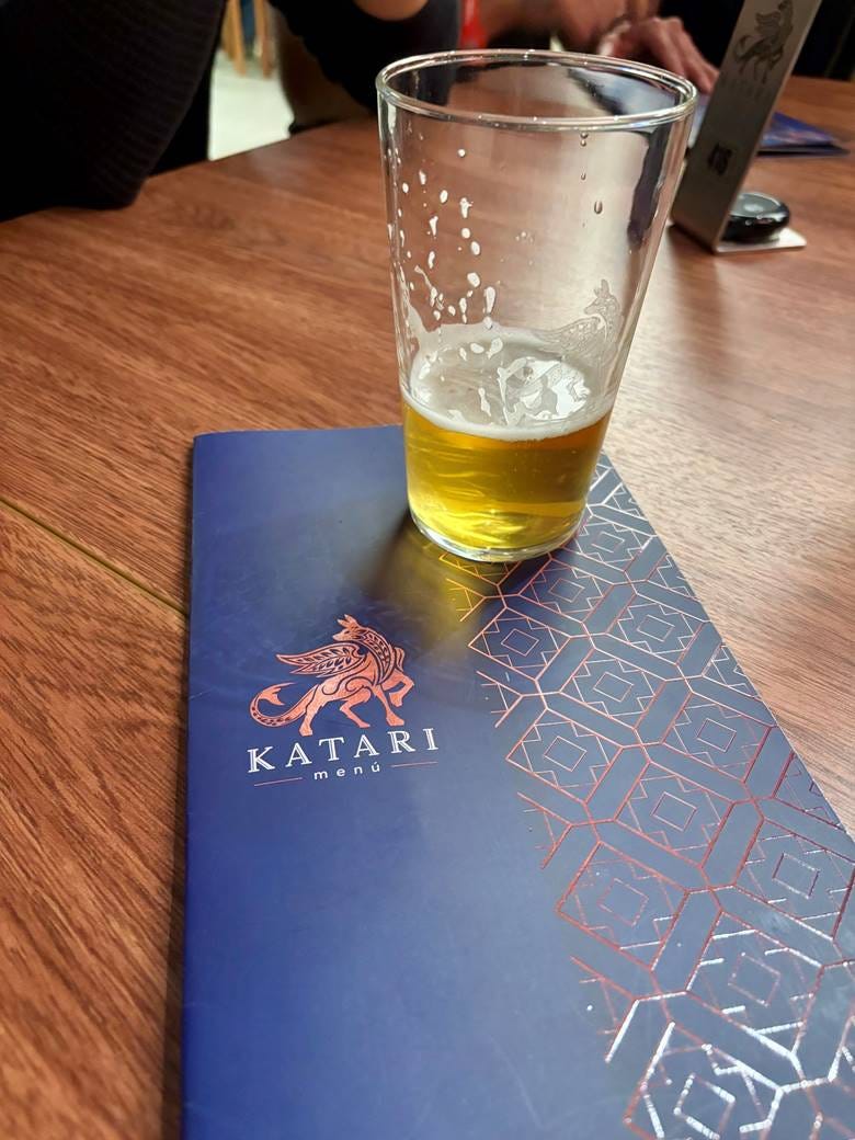 A glass of beer on a table

AI-generated content may be incorrect.