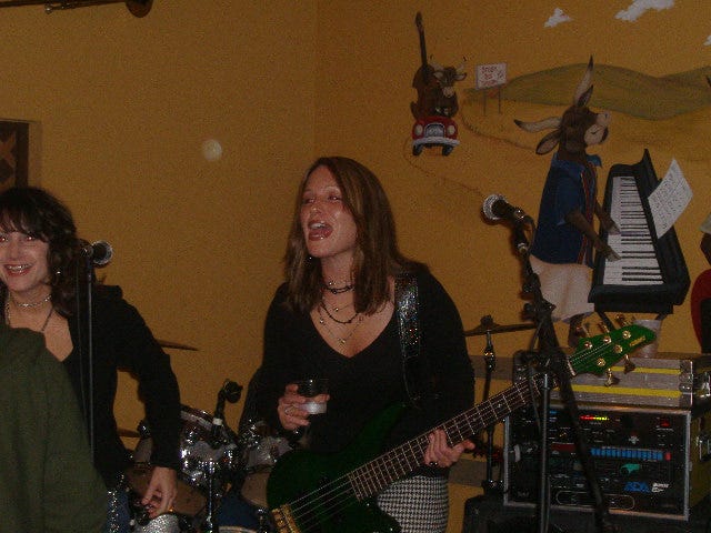 She isn't quite dressed as black as coal, but she did pretty much stand like Bill Wyman. That reference will probably go right over the head of 99 percent of my readers. Guys like me dig chicks with bass. She isn't quite dressed as black as coal, but she did pretty much stand like Bill Wyman. That reference will probably go right over the head of 99 percent of my readers. Guys like me dig chicks with bass.