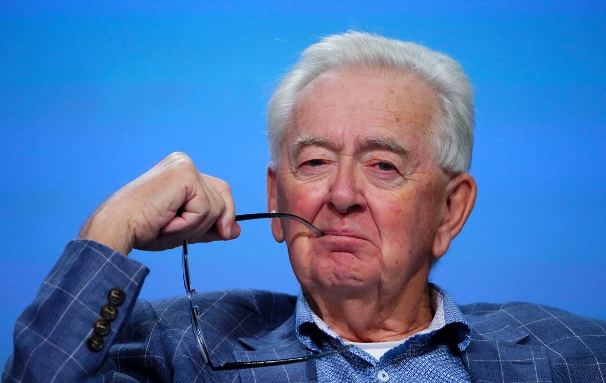 a man holding a pair of glasses