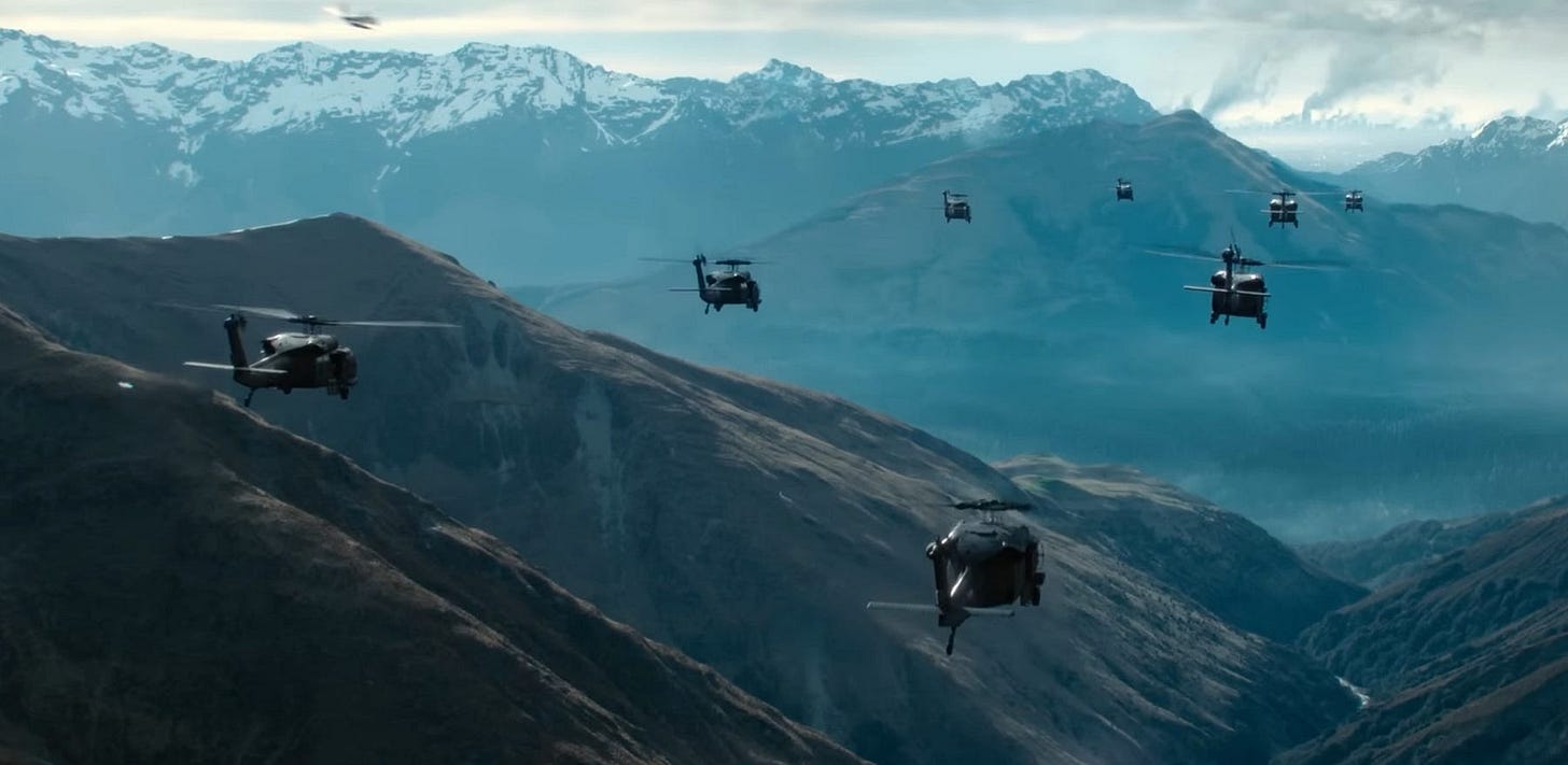 Seven Black Hawk helicopters flying in formation over mountains.